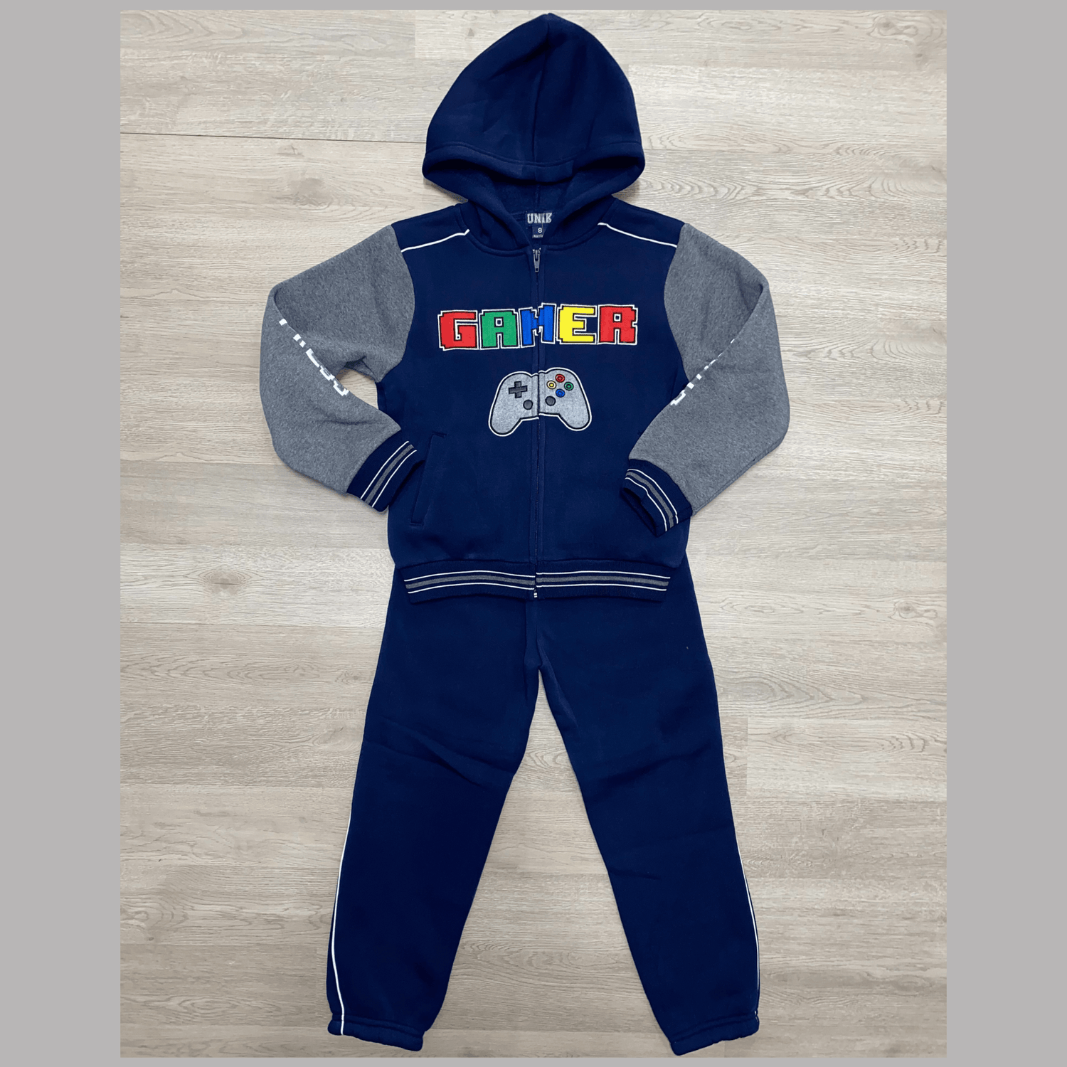 Fun gamer fleece set with hoodie. This colorful and fun set features "Gamer" and a picture of a controller embroidered on the front. It also has embroidered arms with "Push" and "Start". This is a great set for all of the little gamers out there. This set features a zipper front hoodie and elastic around the ankles.