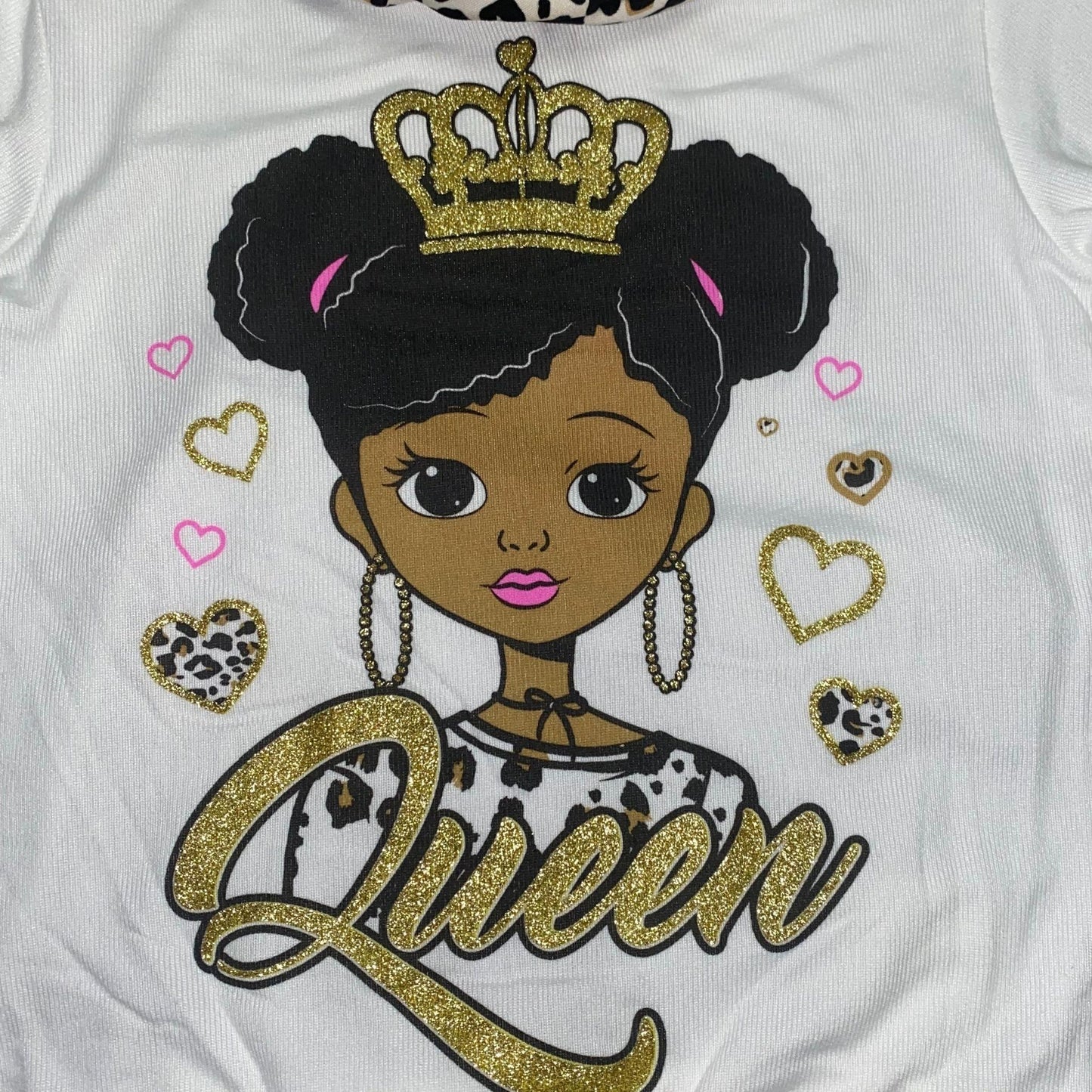 Get ready for fall in this cozy legging set. This set features an ivory colored top with a screen pressed "Queen" design and cheetah print leggings. The top also has an attached cheetah print scarf to complete the outfit.