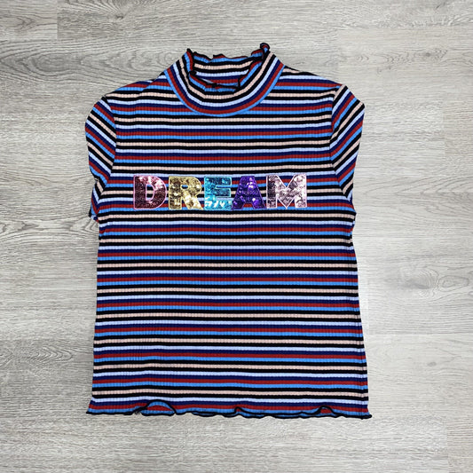 Our ruffle sleeved "DREAM" shirt is a perfect addition to the wardrobe of the little lady in your life.  This shirt features long sleeves and a mock turtle neck with scalloped edges.  This shirt has red, navy, and blue stripes with the word "DREAM" in sequins.