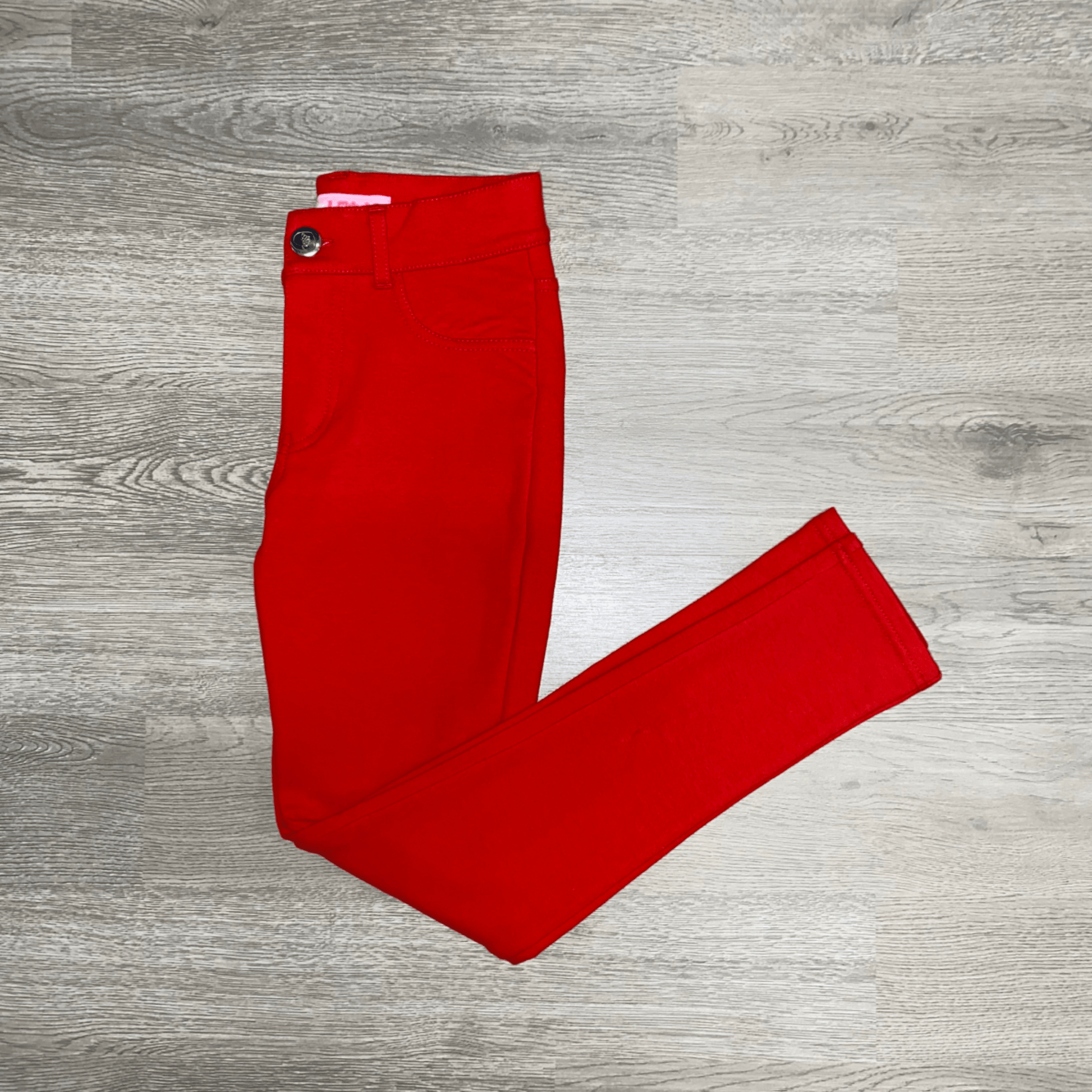 These comfortable, stretchy, red jeggings are a perfect addition to your little diva's wardrobe.  This style features a button closure and pockets on the back.